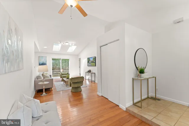 a living room with fireplace furniture and a wooden floor
