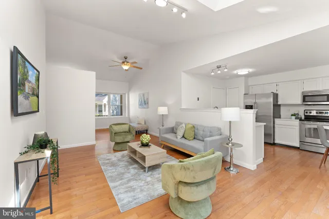 a living room with furniture and a kitchen view