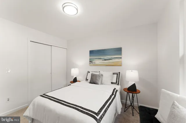 a bedroom with a bed and a potted plant