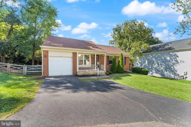 a view of a house with a yard and a patio