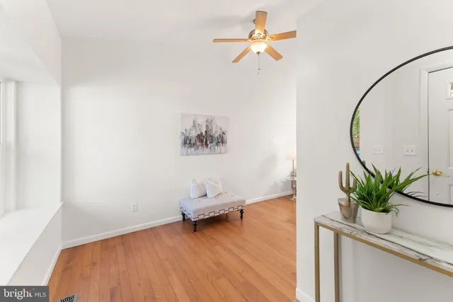 a view of a room with wooden floor and a potted plant