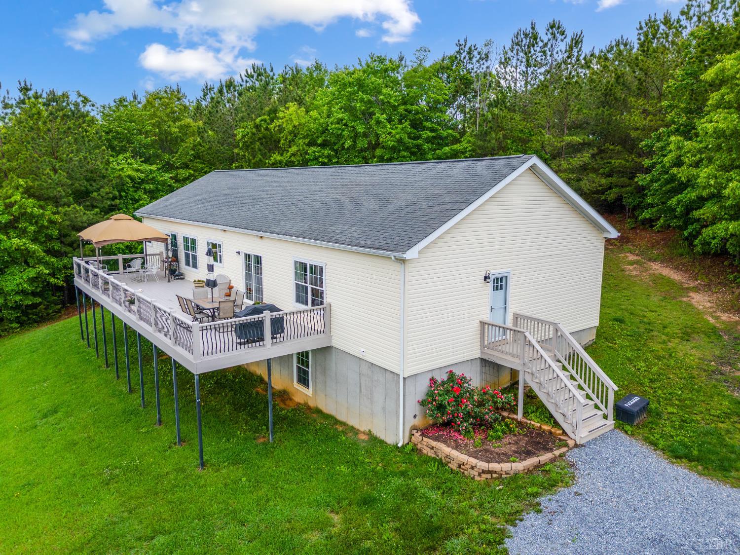 491 Pacoman Road Evington, VA 24550 - Photo 5 of 77 a aerial view of a house with a yard table and chairs