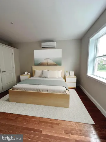 a spacious bedroom with a bed and window