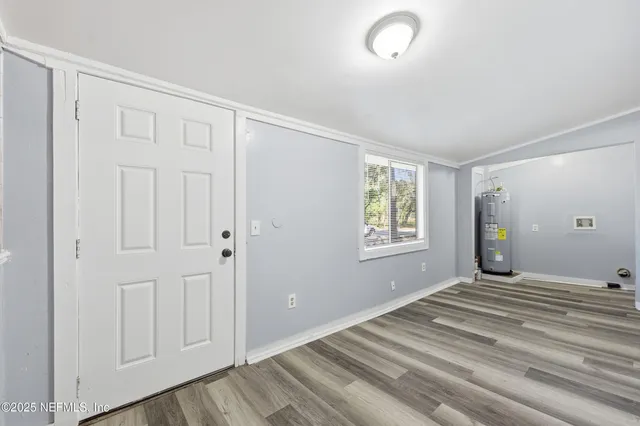 a view of a livingroom with an empty space wooden floor and window
