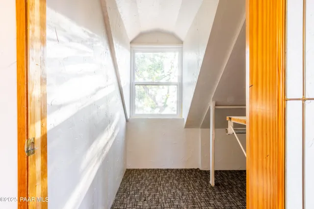 a view of a room with wooden floor and windows