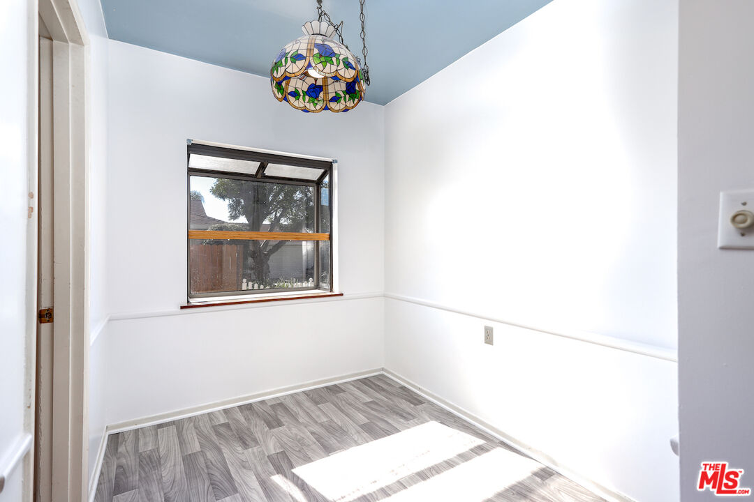 10310 Cullman Avenue Whittier, CA 90603 - Photo 14 of 30 a view of an empty room with wooden floor and a window