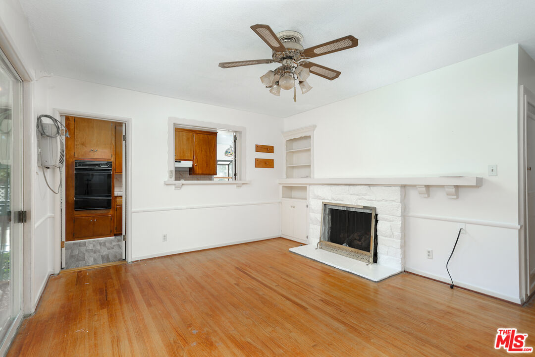 10310 Cullman Avenue Whittier, CA 90603 - Photo 19 of 30 wooden floor fireplace and windows in an empty room