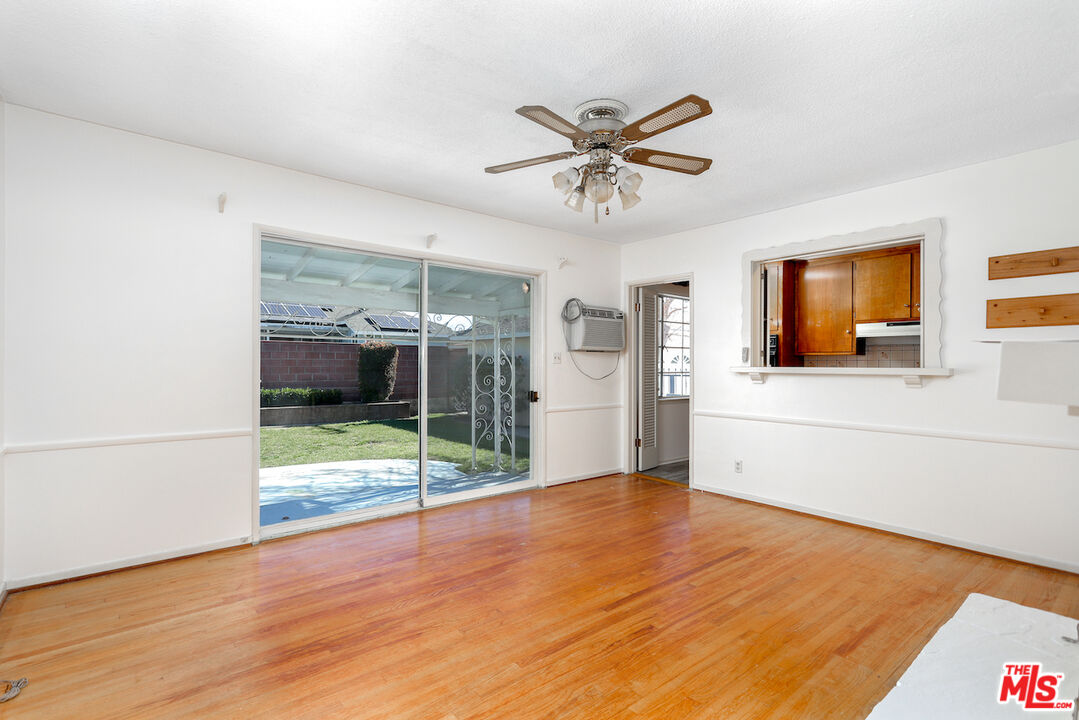 10310 Cullman Avenue Whittier, CA 90603 - Photo 20 of 30 a view of a livingroom with wooden floor and a ceiling fan