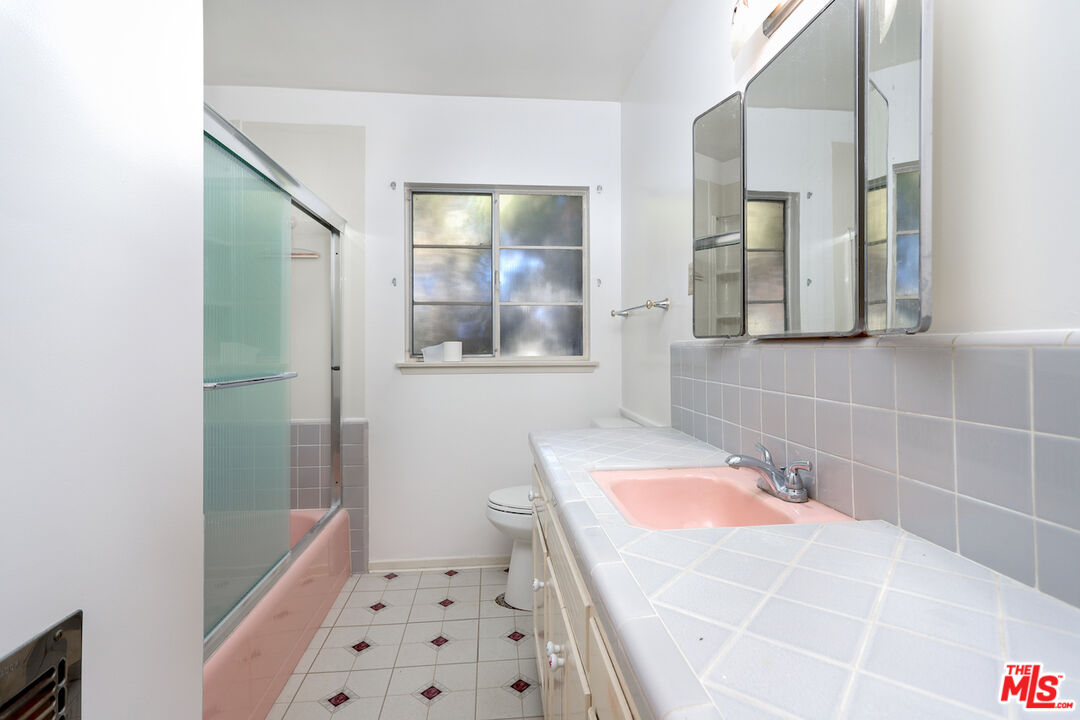 10310 Cullman Avenue Whittier, CA 90603 - Photo 22 of 30 a bathroom with a sink a toilet and shower