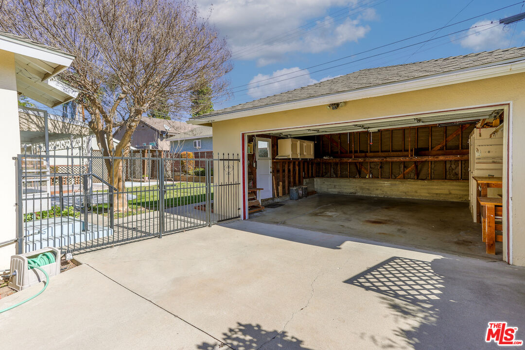 10310 Cullman Avenue Whittier, CA 90603 - Photo 30 of 30 a view of backyard with large trees and wooden fence