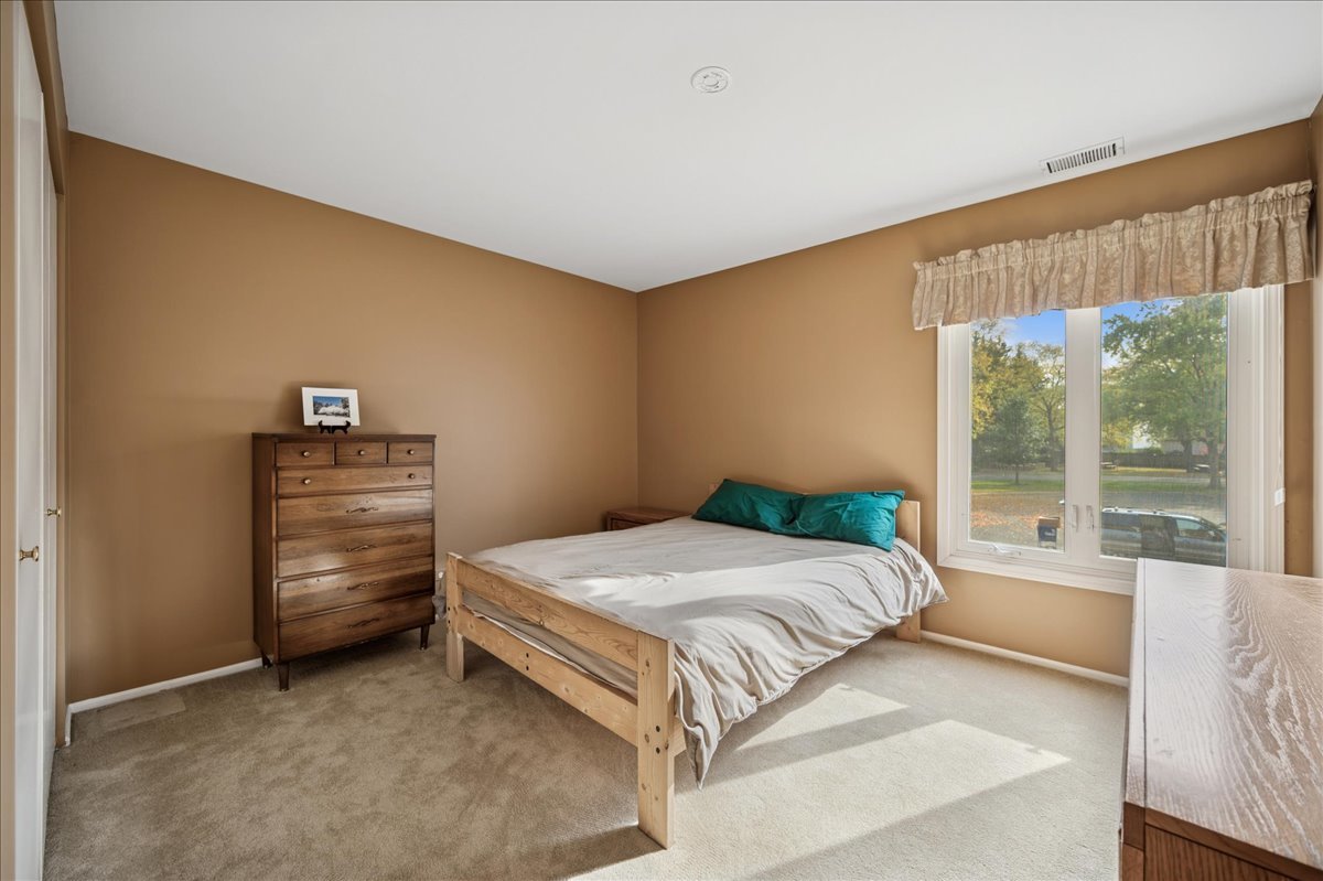 175 Lake Boulevard, Unit 301 Buffalo Grove, IL 60089 - Photo 11 of 15 a bedroom with a bed and large window