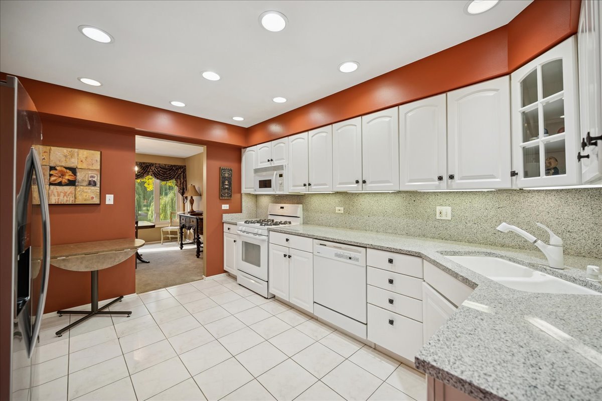 175 Lake Boulevard, Unit 301 Buffalo Grove, IL 60089 - Photo 3 of 15 a large white kitchen with cabinets