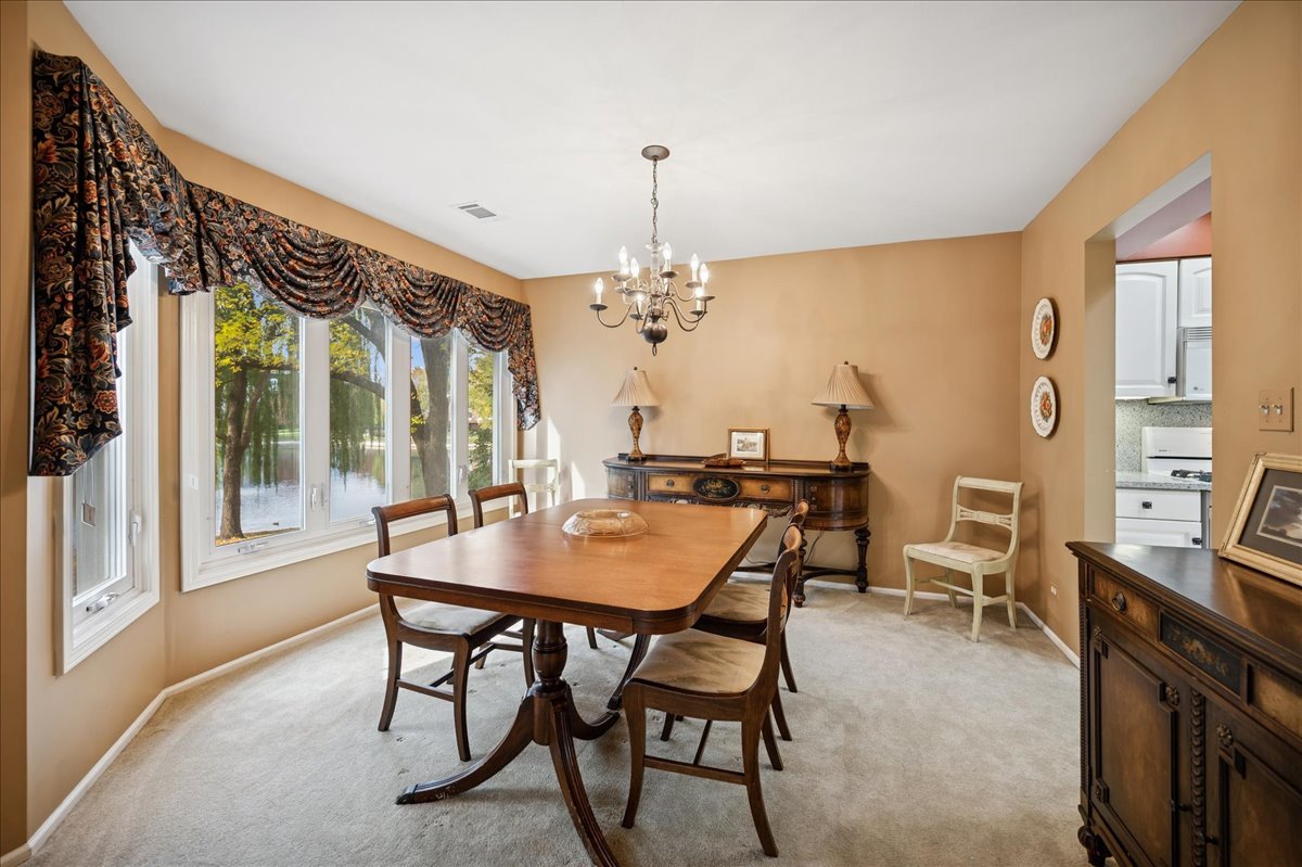 175 Lake Boulevard, Unit 301 Buffalo Grove, IL 60089 - Photo 5 of 15 a view of a dining room with furniture window and wooden floor