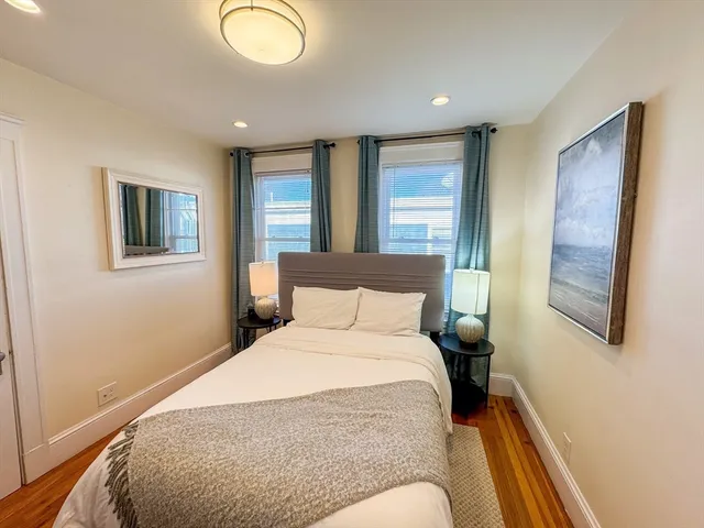 a bedroom with a large bed and a window