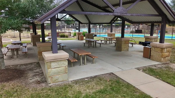 a view of a patio with table and chairs under an umbrella