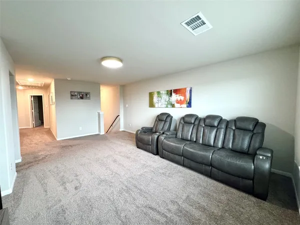 a view of living room filled with furniture and a window