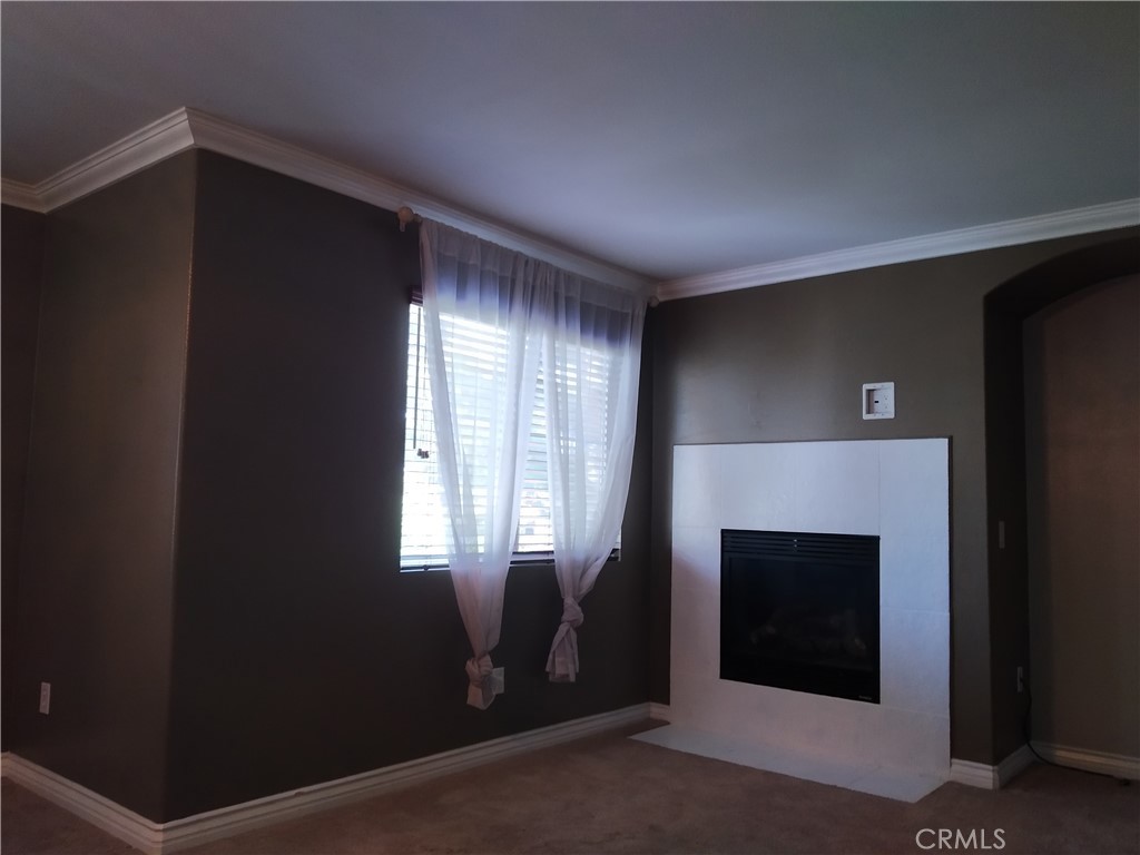 7715 Abbot Court Rancho Cucamonga, CA 91730 - Photo 11 of 22 a view of an empty room with a fireplace