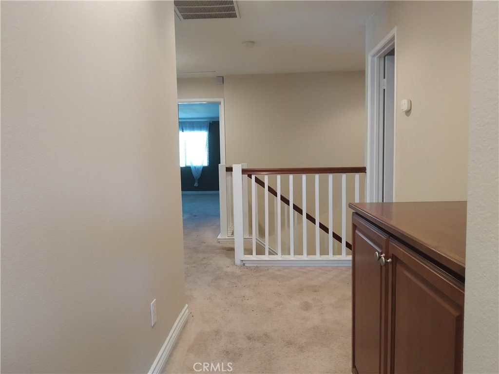 7715 Abbot Court Rancho Cucamonga, CA 91730 - Photo 21 of 22 a view of a hallway with staircase
