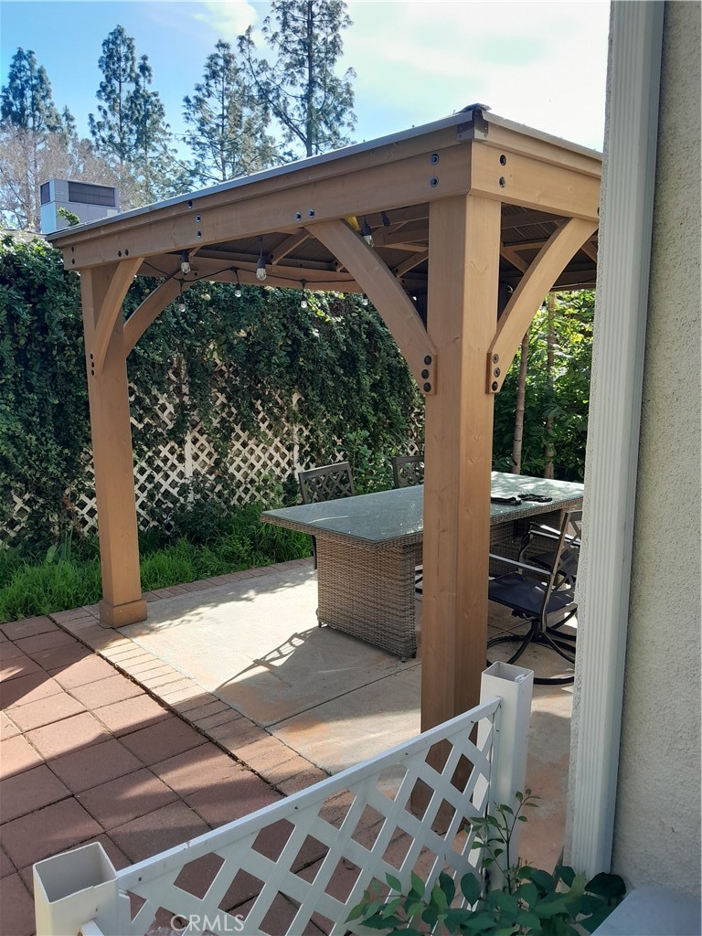7715 Abbot Court Rancho Cucamonga, CA 91730 - Photo 4 of 22 a view of a patio with table and chairs with wooden floor and fence