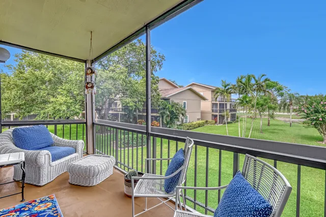 a living room with furniture a flat screen tv and a large window