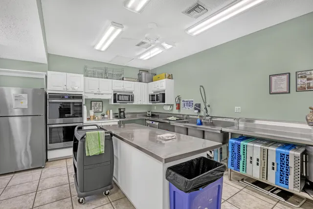 a swimming pool view with a seating space and a garden view