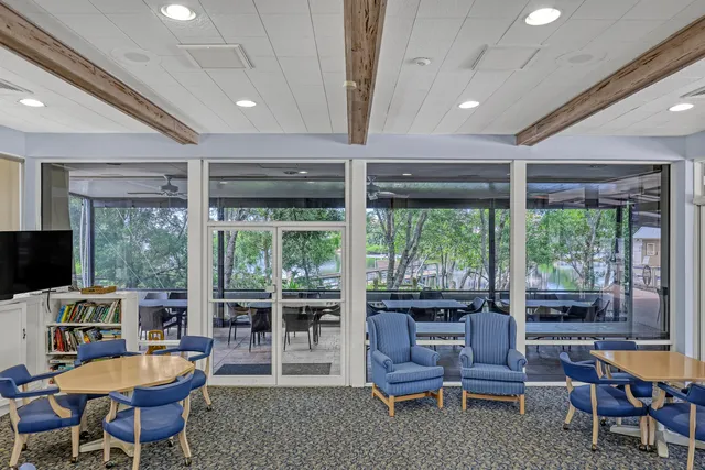 a swimming pool with outdoor seating and yard