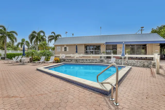 an aerial view of a house with a garden and lake view
