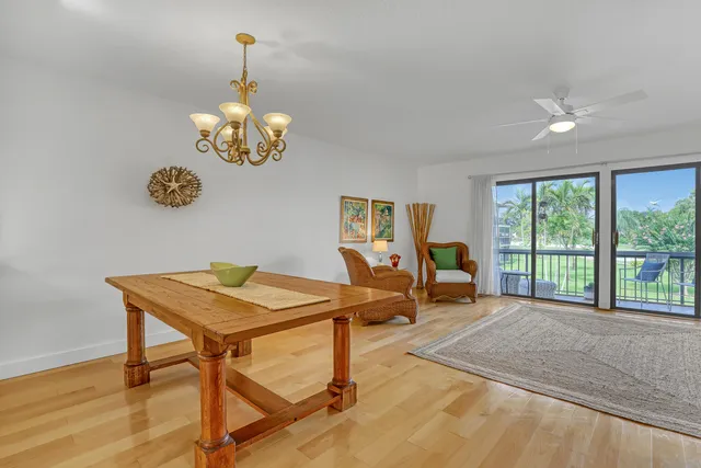 a view of a dining room with furniture and a chandelier