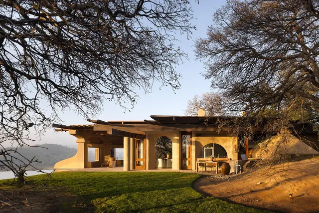 a living room with furniture a large window and a chandelier