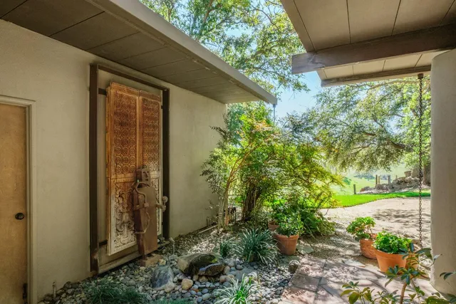 a front view of a house with trees