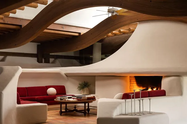 a living room filled with furniture and a black umbrella