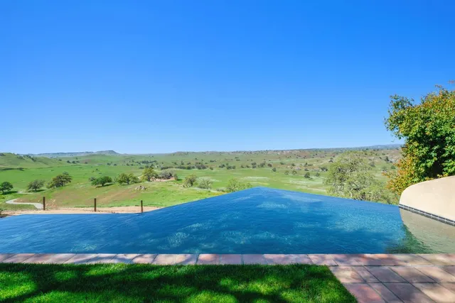 a front view of a building with trees