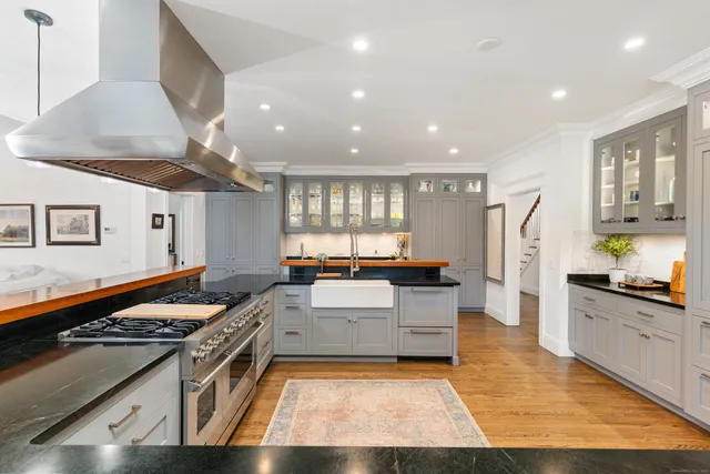 a kitchen with stainless steel appliances granite countertop a stove and a sink
