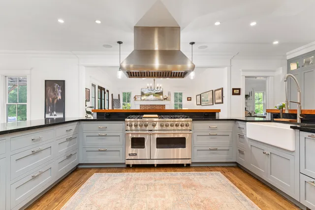 a kitchen with granite countertop cabinets and wooden floor