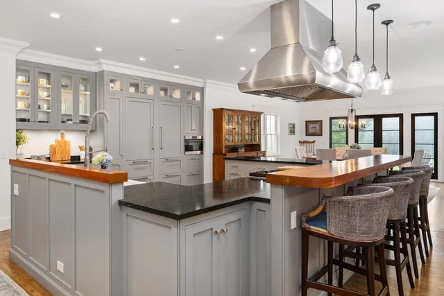 a kitchen with stainless steel appliances a stove sink and cabinets