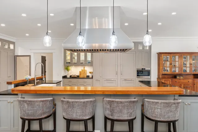 a kitchen with stainless steel appliances granite countertop a sink and cabinets