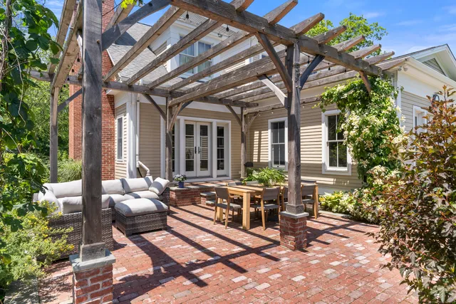 a living room with furniture a fireplace and a chandelier