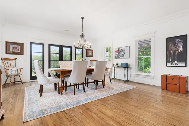 a view of a dining room with furniture wooden floor and a chandelier