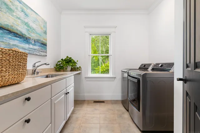 a bathroom with a sink mirror toilet and a window