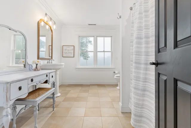 a living room with furniture flat screen tv and a window