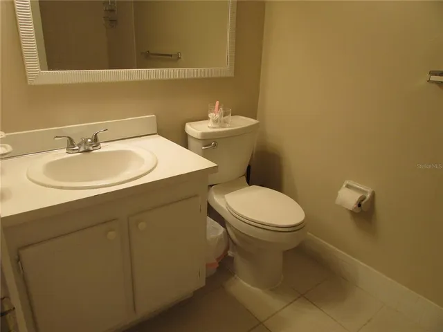 a bathroom with a sink mirror and toilet
