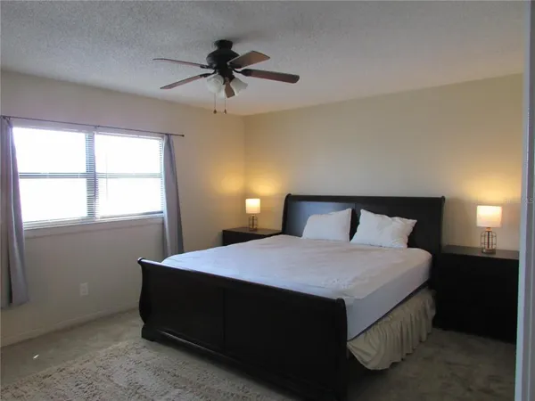 a bedroom with a bed and window