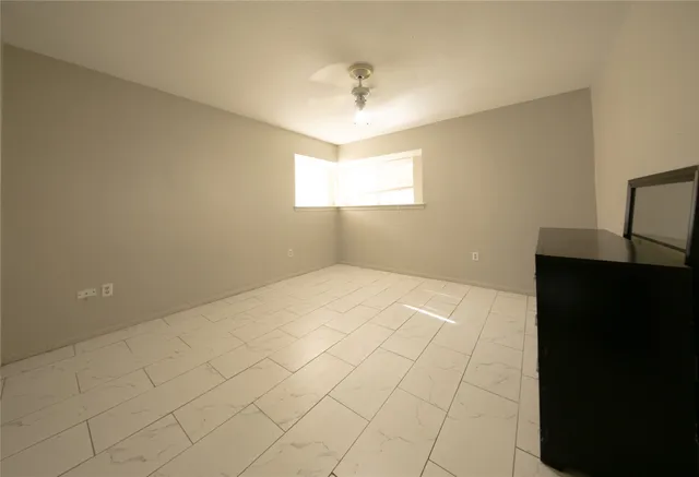 a view of an empty room and a window