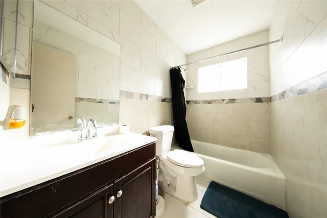 a bathroom with a sink a toilet and bathtub