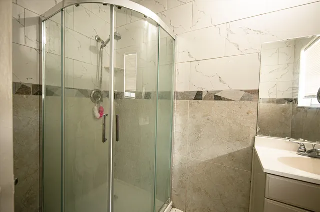 a bathroom with a shower and a sink