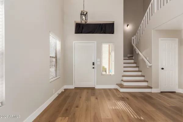 a view of a livingroom with wooden floor and stairs