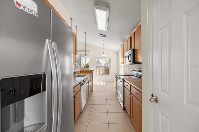 a kitchen with stainless steel appliances a refrigerator and a stove