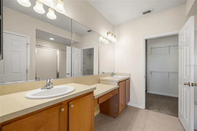 a bathroom with a sink double vanity and a mirror