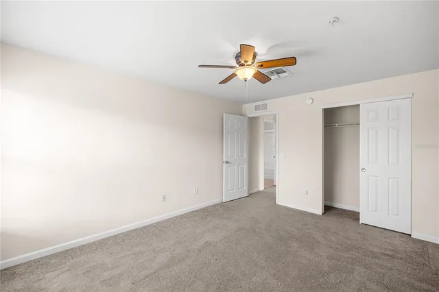 a view of room with a ceiling fan and window