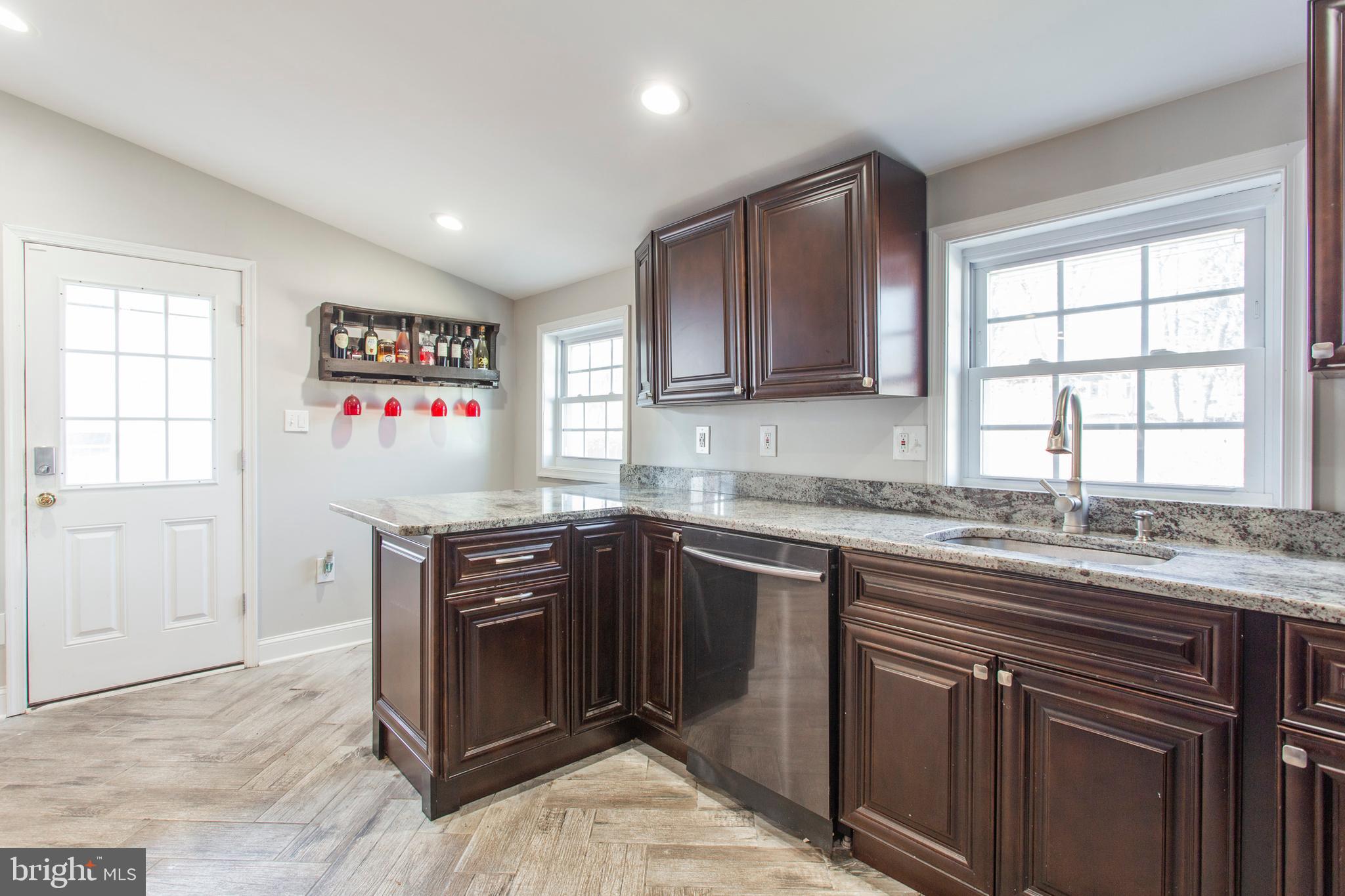 1025 Edgerton Road Secane, PA 19018 - Photo 11 of 21 a kitchen with stainless steel appliances granite countertop a stove a sink and a microwave